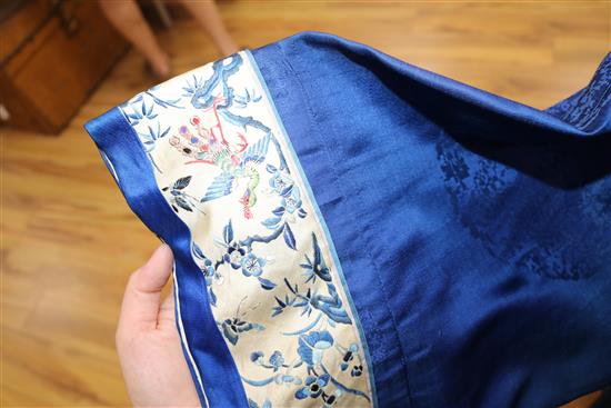 A Chinese silk embroidered robe c.1920s, embroidered with panels of birds and flowers on royal blue silk